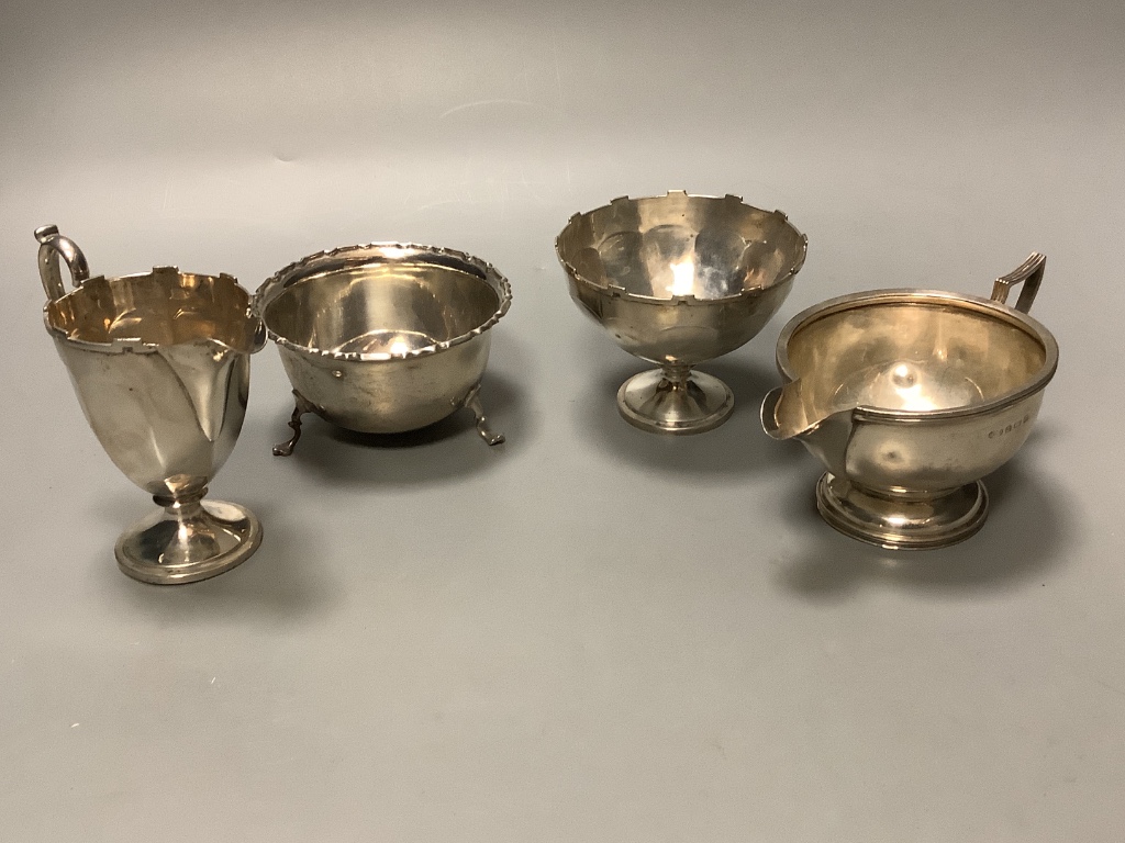 Two George V silver cream jugs and two similar silver sugar bowls